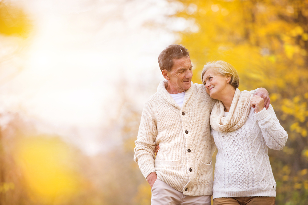 couple in the fall leaves preventing back pain