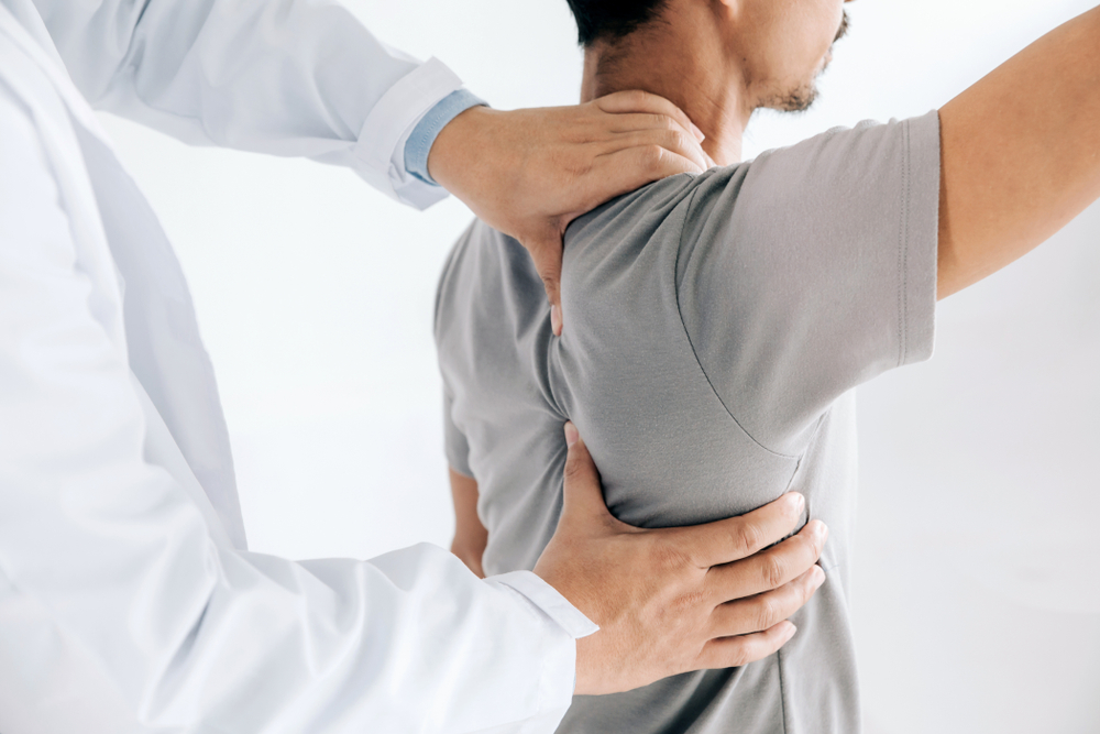doctor helping patient's range of motion and shoulder pain
