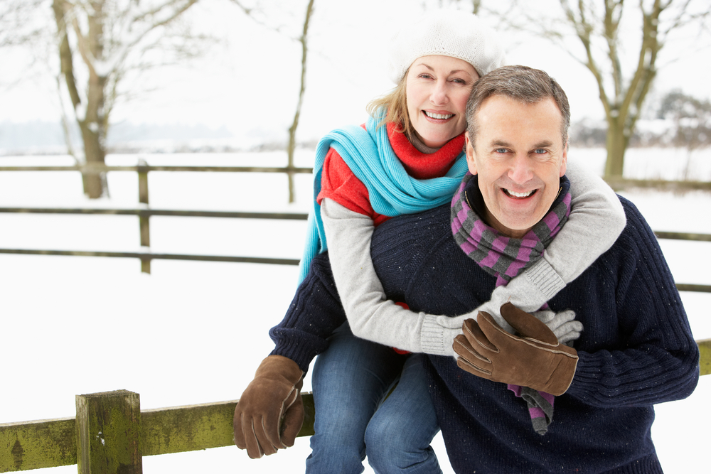 couple with arthritis pain out in snow
