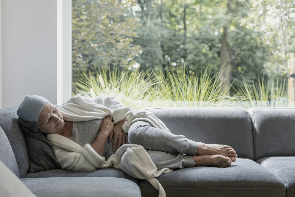 woman on couch cancer pain