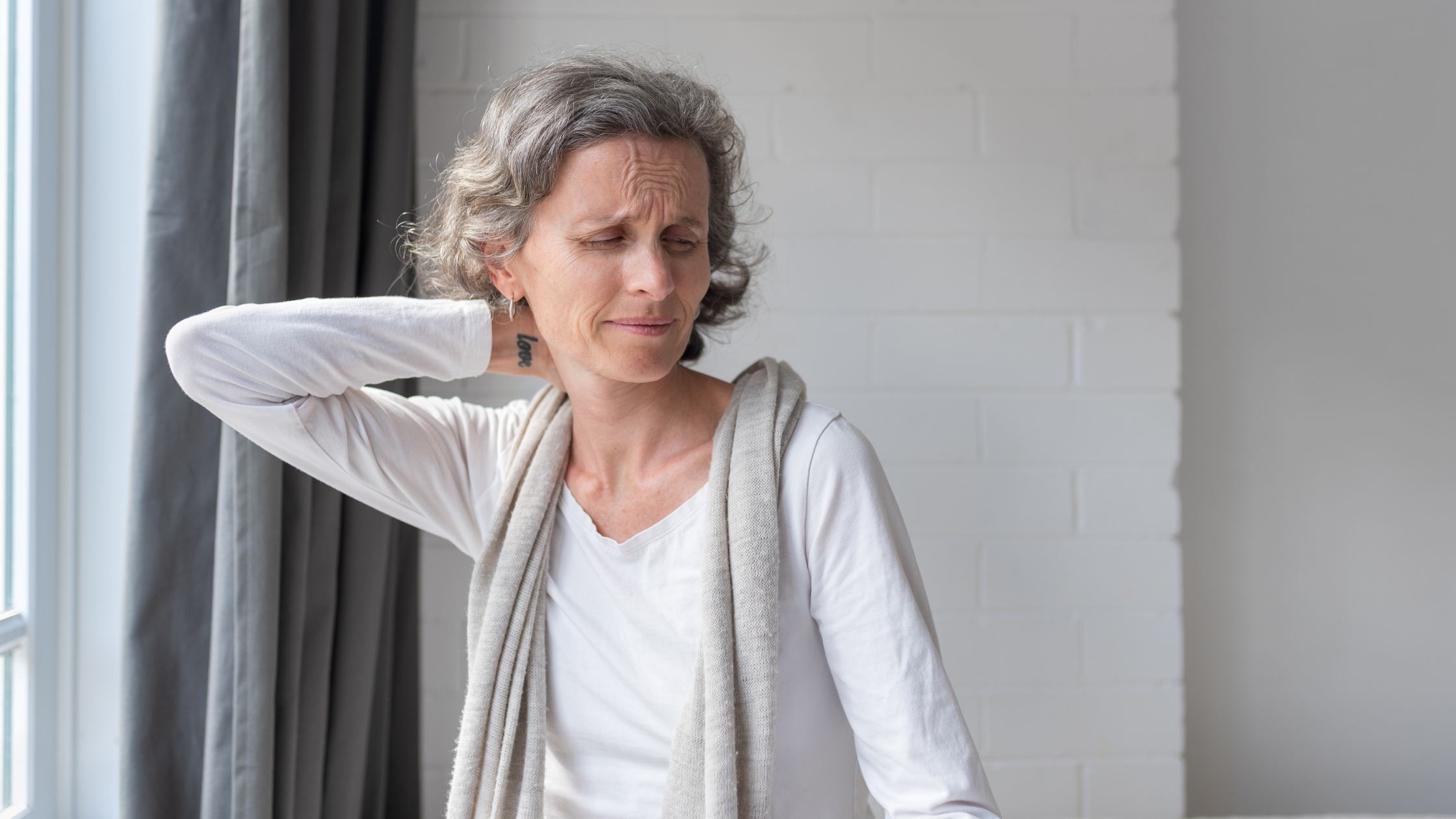 woman rubbing neck to manage chronic pain