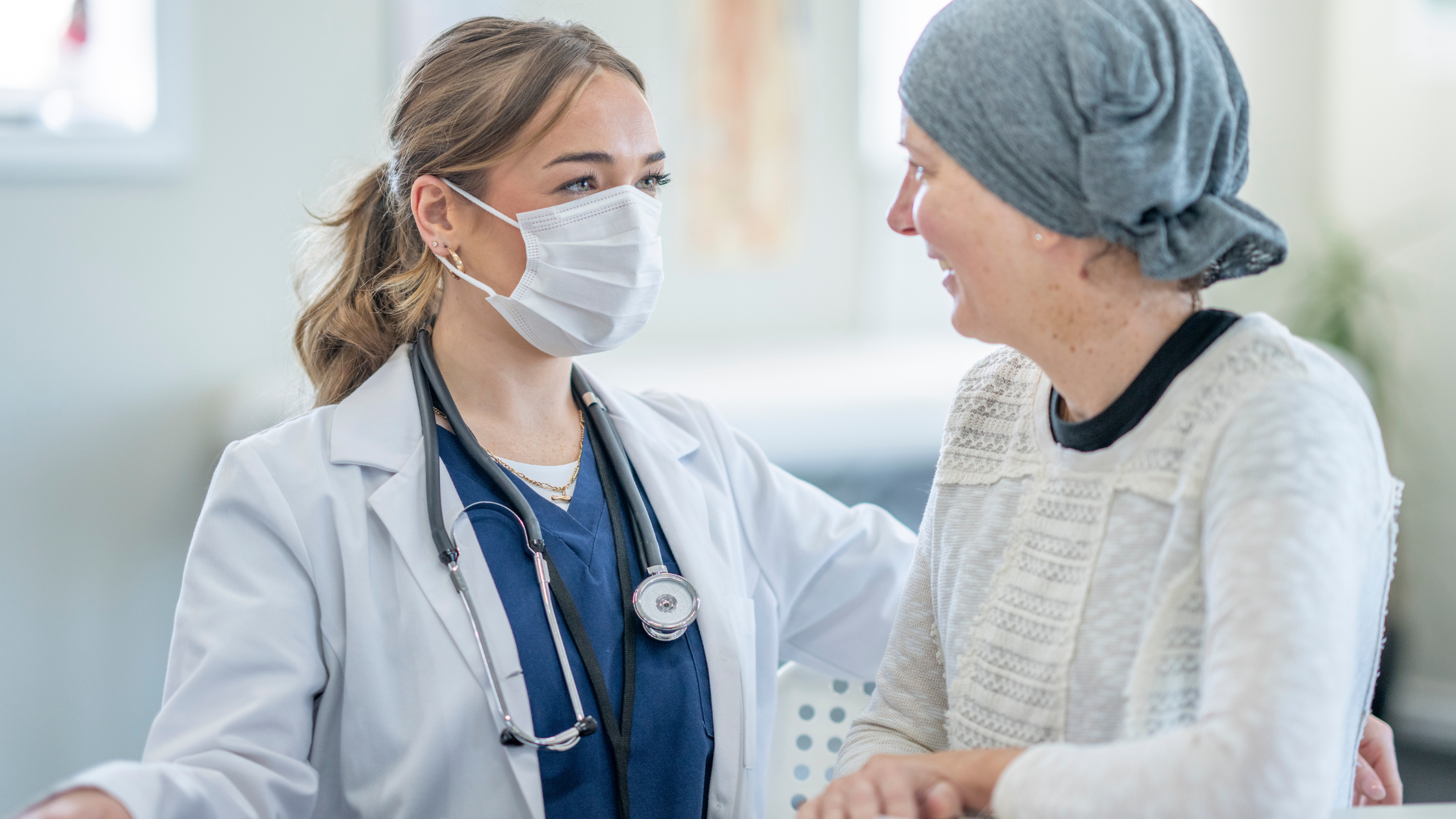 patient with cancer pain talking to doctor